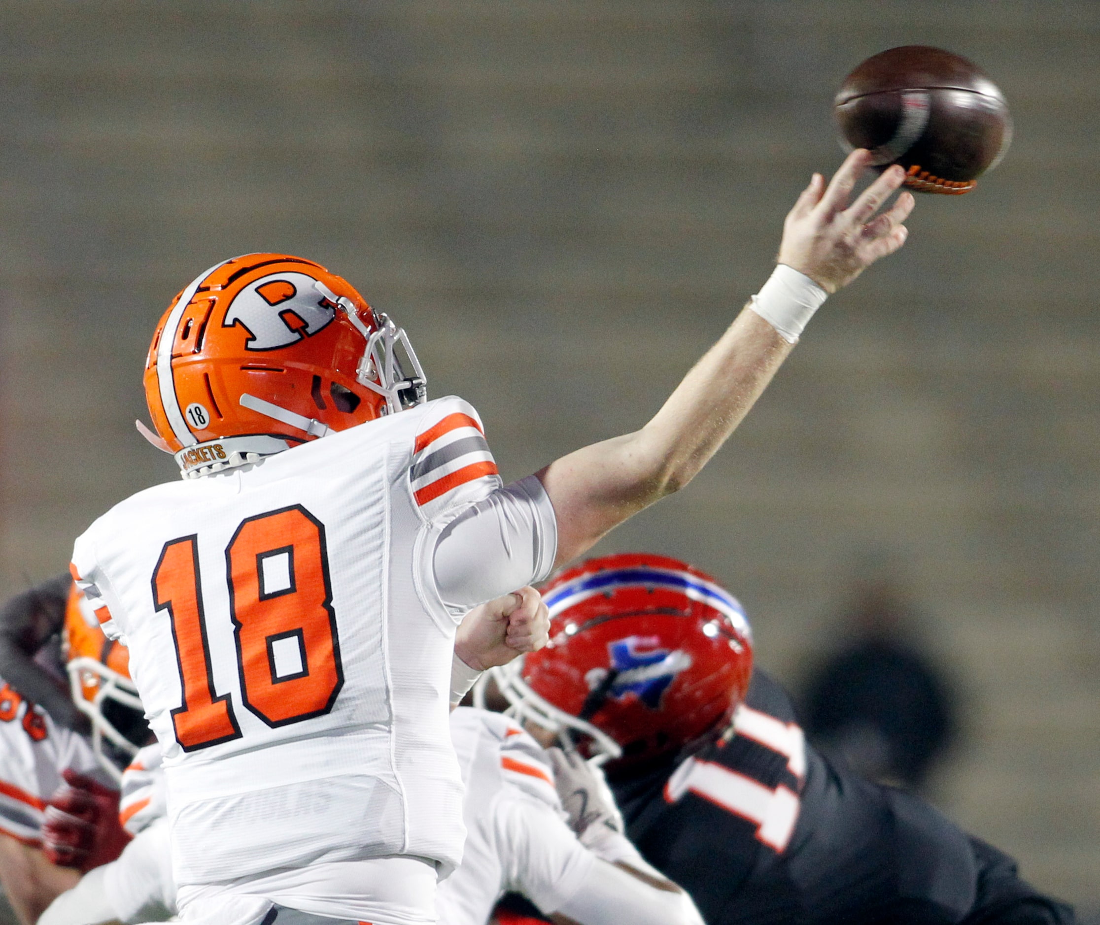 Rockwall quarterback Brent Rickert (18) launches a long pass downfield during first quarter...