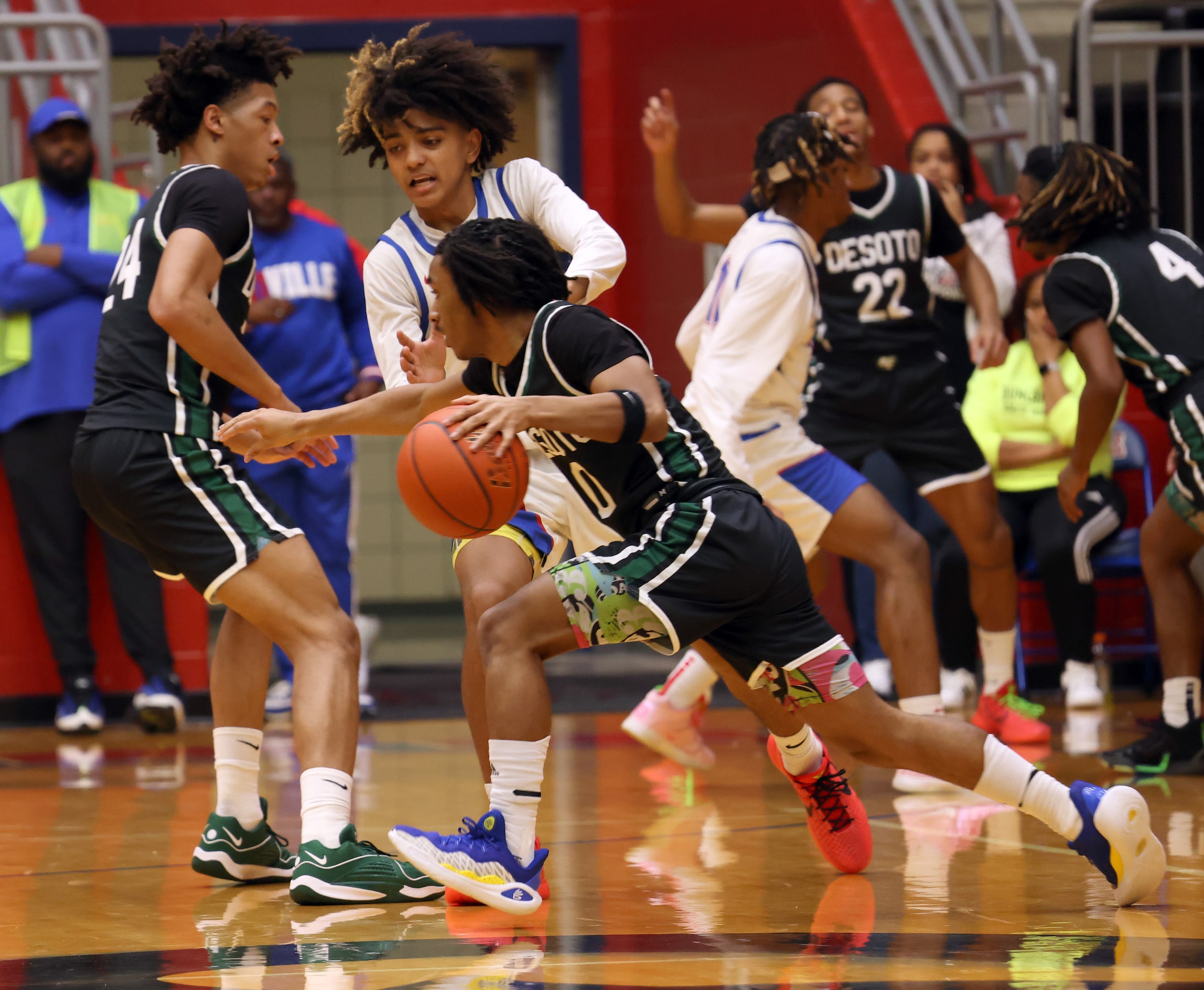 Duncanville guard Beckham Black (0) defends against DeSoto guard Miles Pitt (0) as he drives...