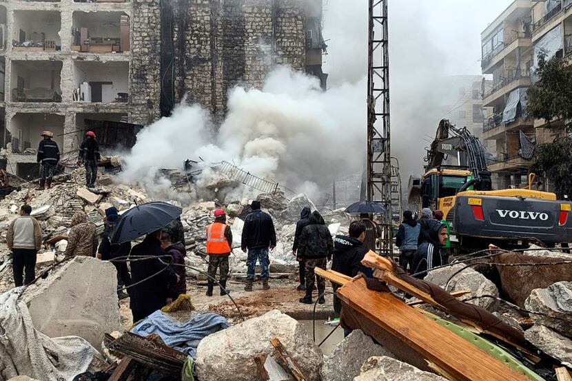 In this photo released by the Syrian official news agency SANA, civil defense workers and...