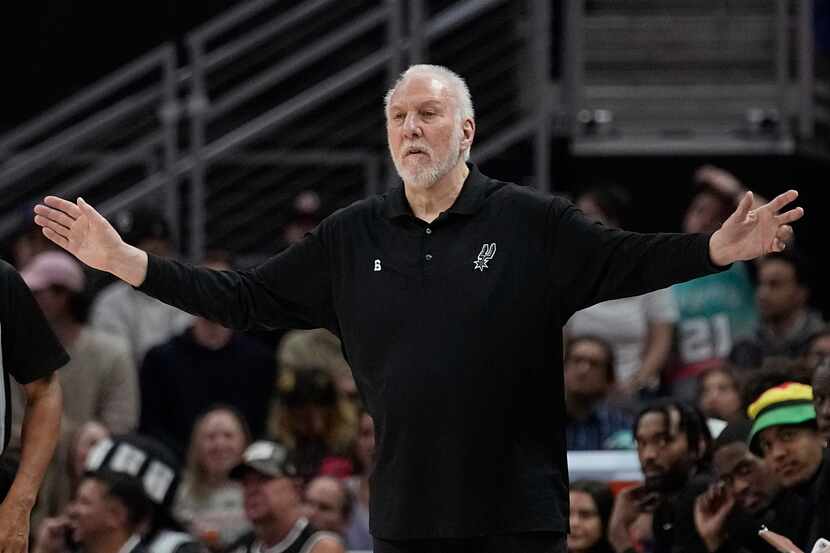 San Antonio Spurs head coach Gregg Popovich signals to his players during the first half of...
