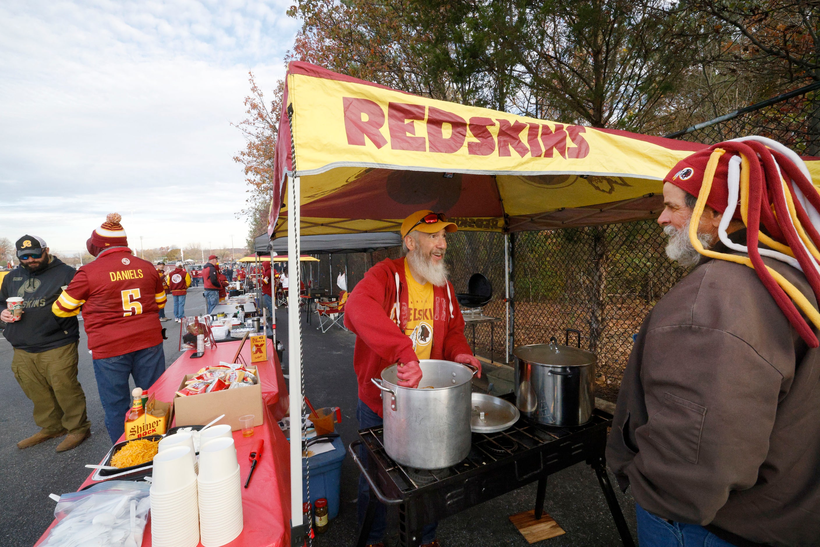 Chris Lopez of Virginia, left, talks with Gary Long of North Carolina as he cooks Texas...