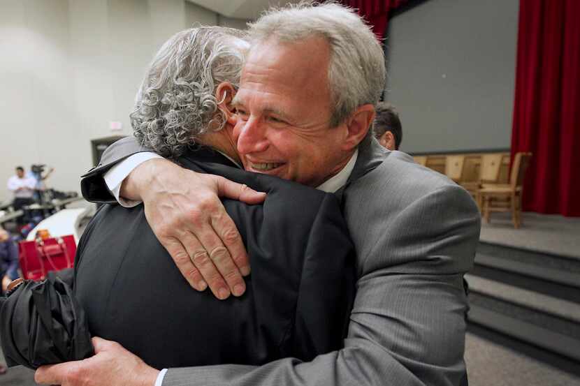 Michael Morton, hugs defense attorney Jerry Goldstein, after speaking to the public for the...