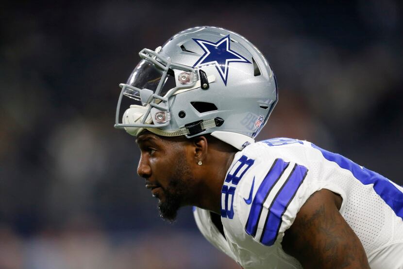 Dallas Cowboys wide receiver Dez Bryant stands on the field warming up before an NFL...