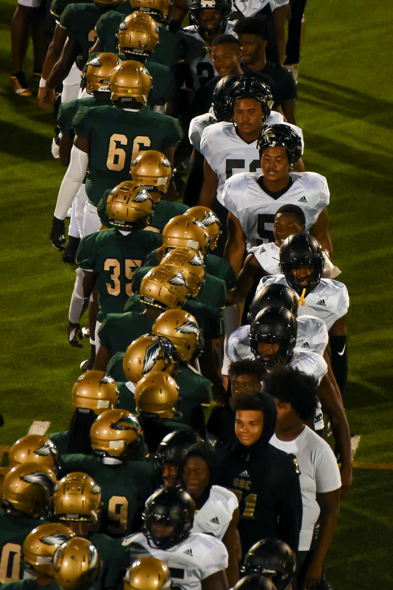Players shake hands following DeSoto’s home game against South Oak Cliff at Eagle Stadium in...