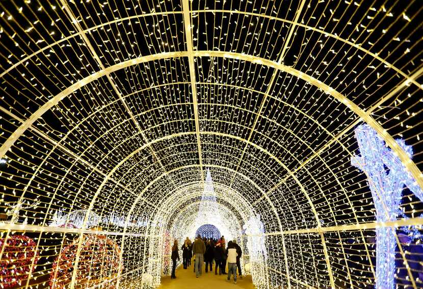 A tunnel of Christmas lights is part of the maze in the Enchant holiday attraction at Globe...