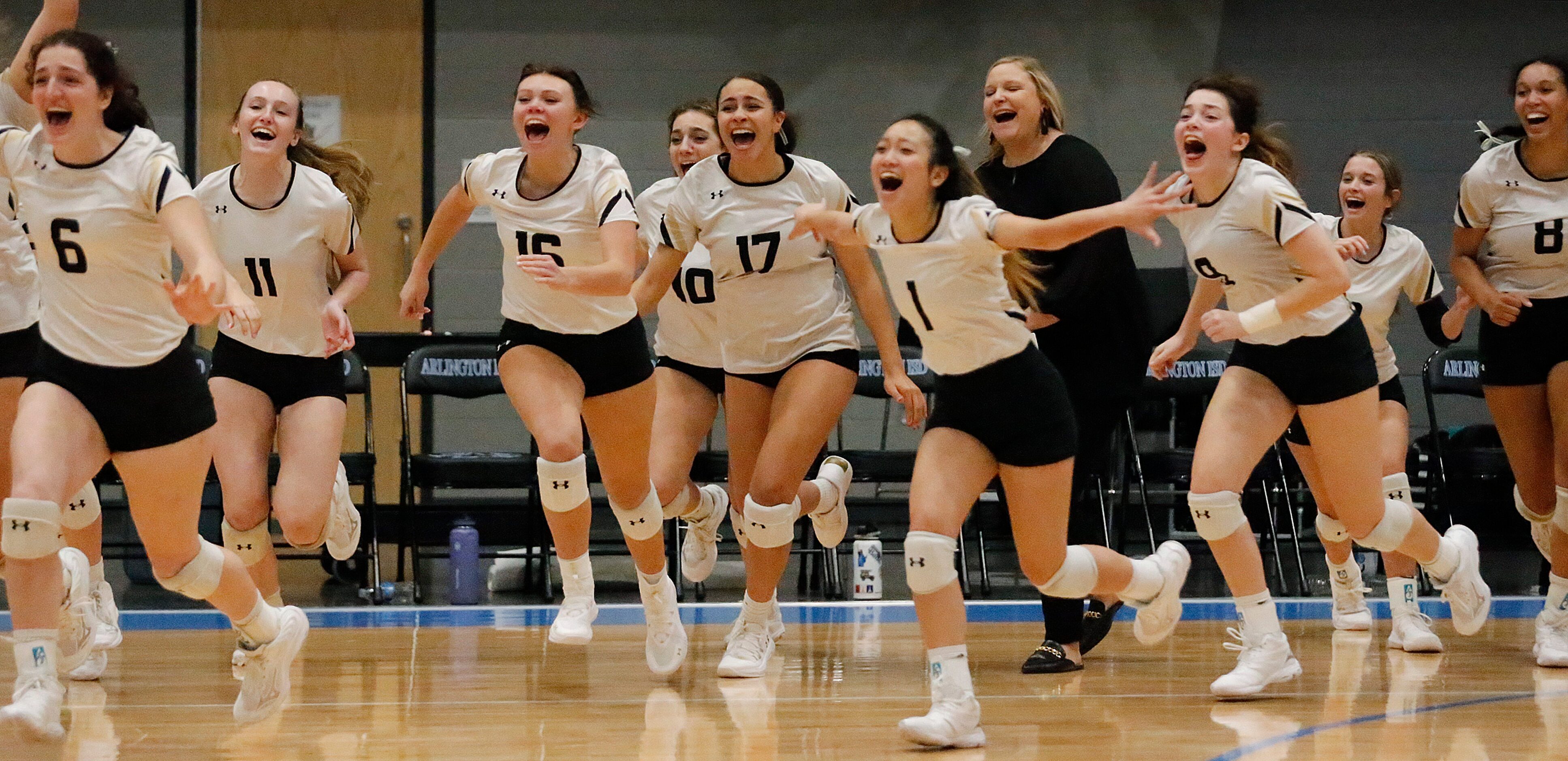 The Mansfield bench rushes the floor as they wien the match during game three as DeSoto High...