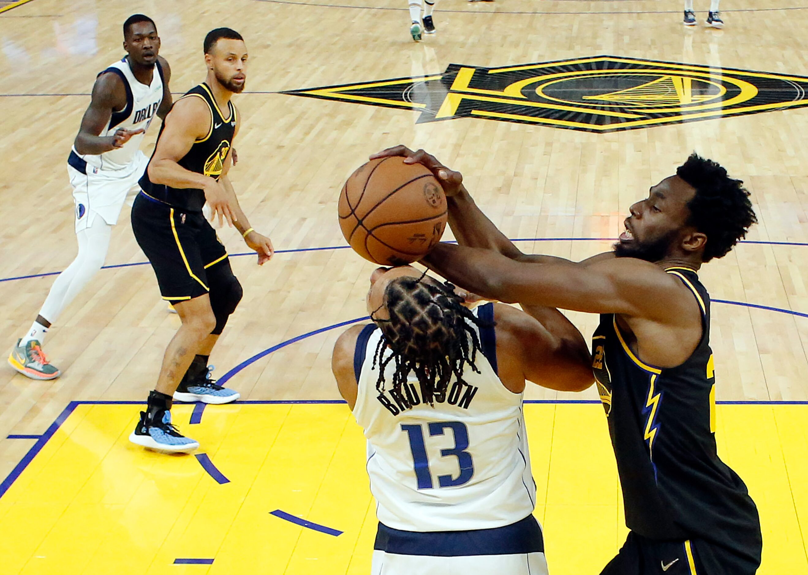 Dallas Mavericks guard Jalen Brunson (13) receives a shot to the face from Golden State...