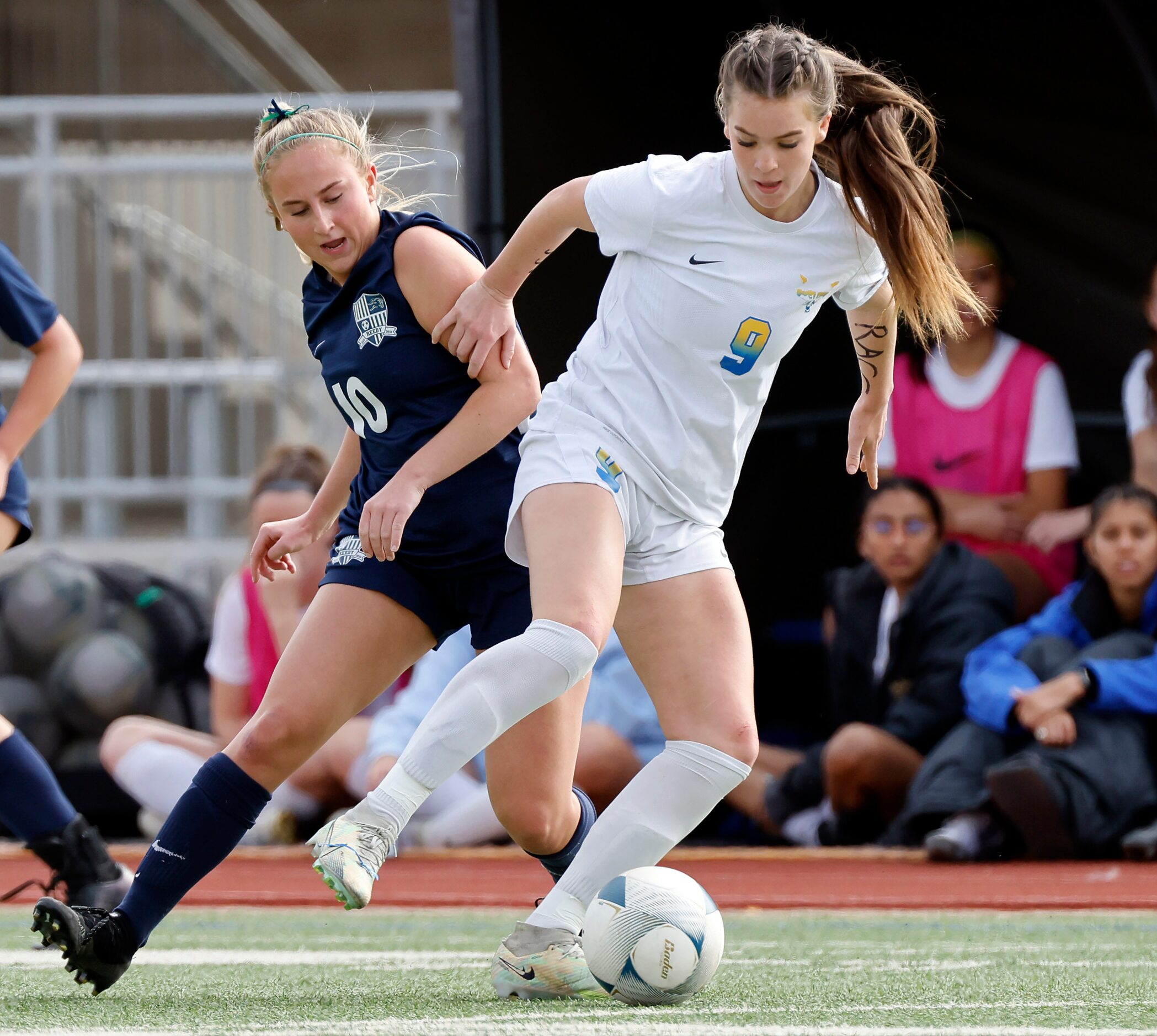 Frisco’s Kat Campbell (9) fends off Frisco Reedy’s Alena Ultes (10) for control of the ball...