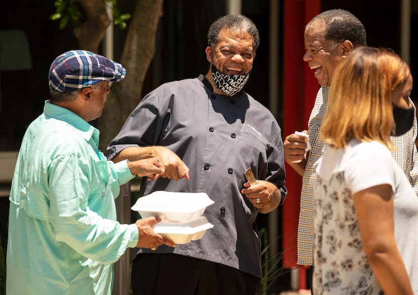 City Men Cook founder Terry Allen (center) visits with Bill McKinney (left) and Arlin...