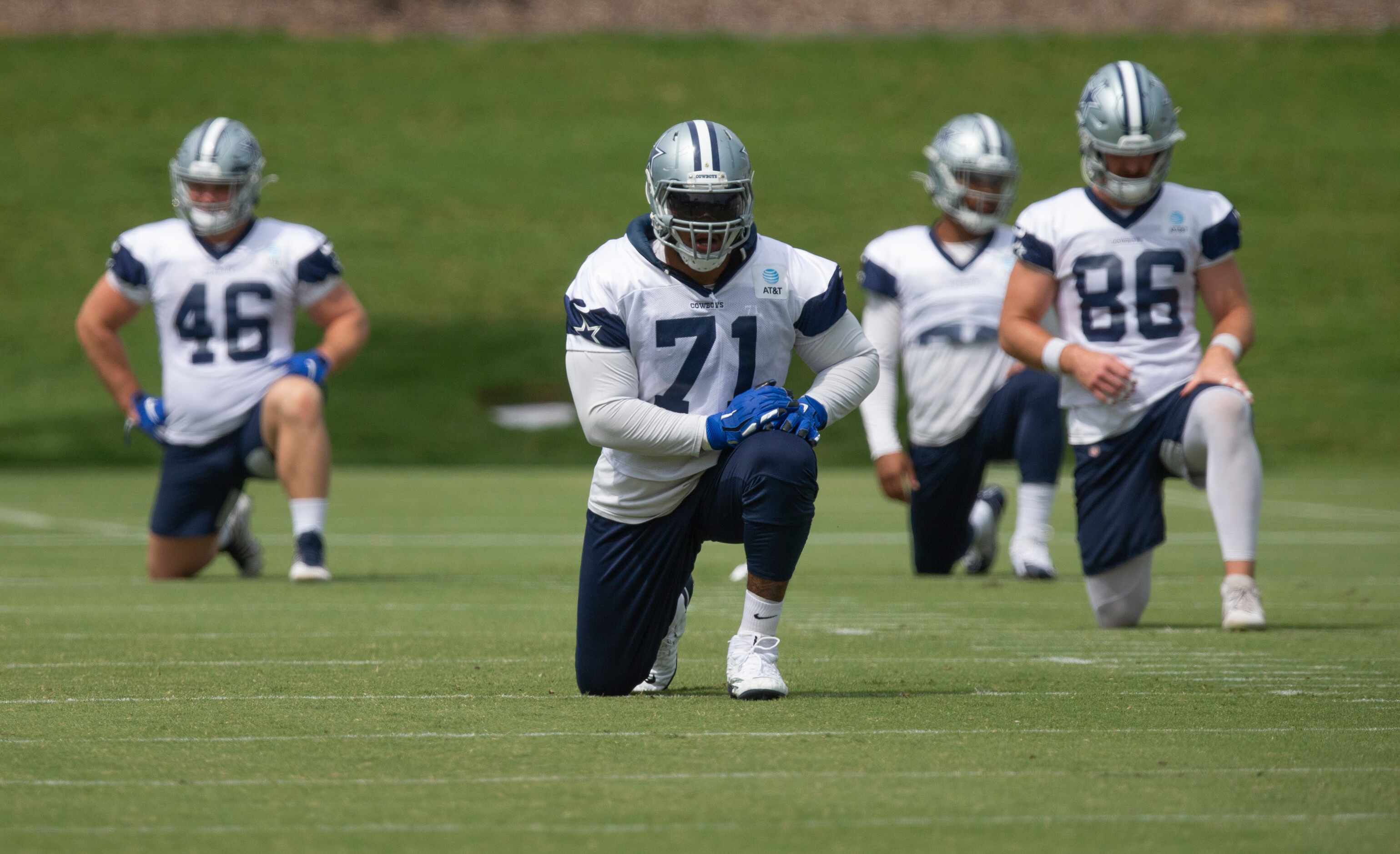 Dallas Cowboys offensive tackle La'el Collins (71) stretches with his teammates during...