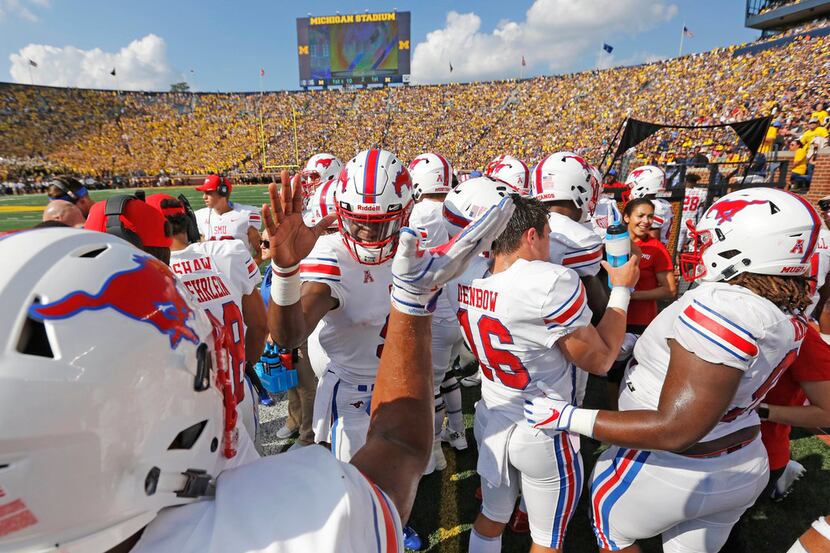 The Mustangs celebrate along the sideline after a first-quarter interception during the SMU...