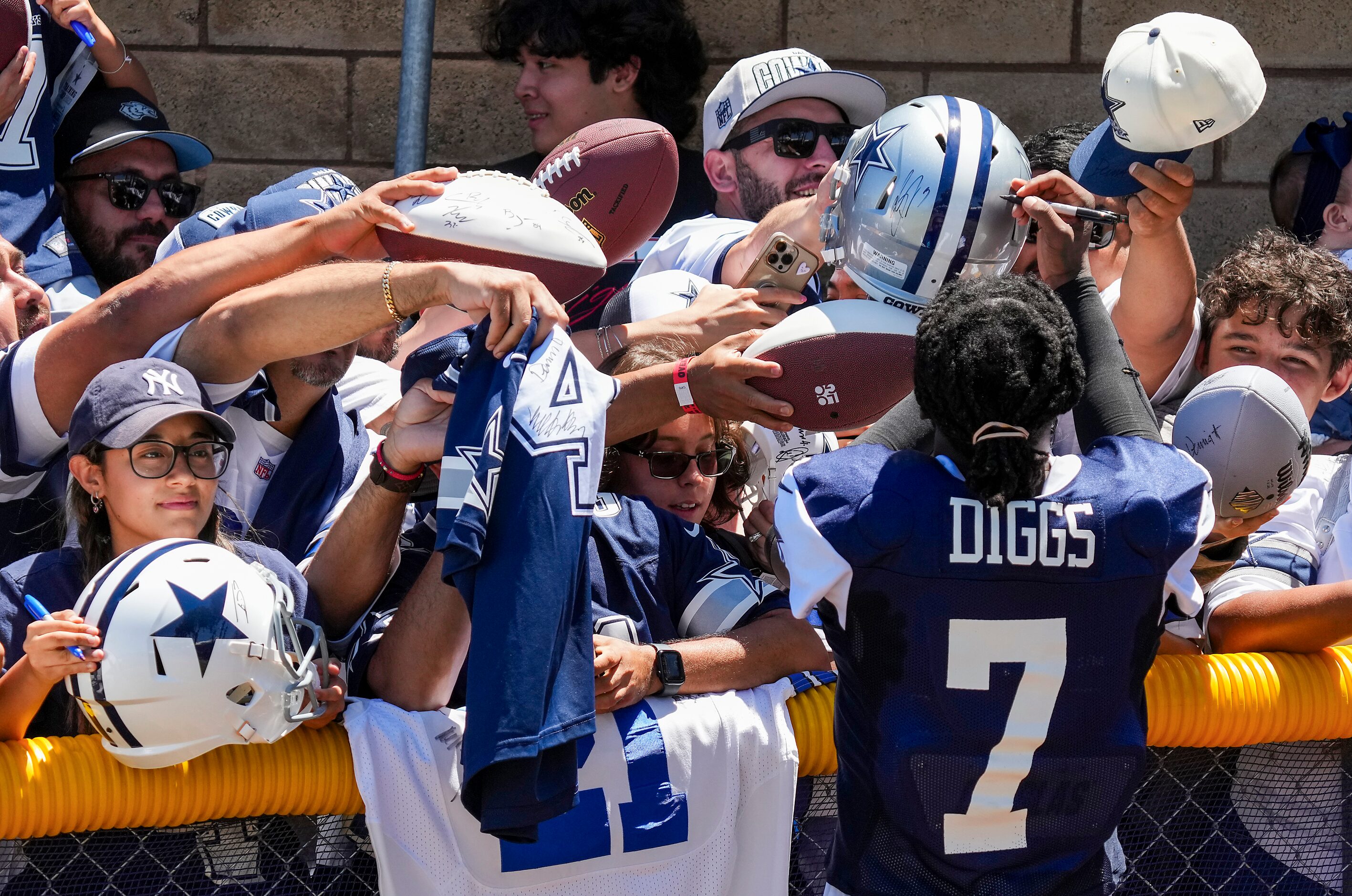 Dallas Cowboys cornerback Trevon Diggs (7) signs autographs after a training camp practice...