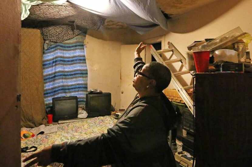 
Joanne Bonner shows a ceiling with water damage in her rental home on Lawrence Street.
