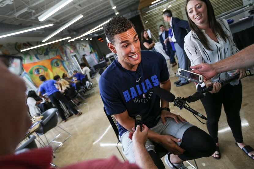 Dallas Mavericks player Dwight Powell talks members of the media as the Mavs Foundation, the...