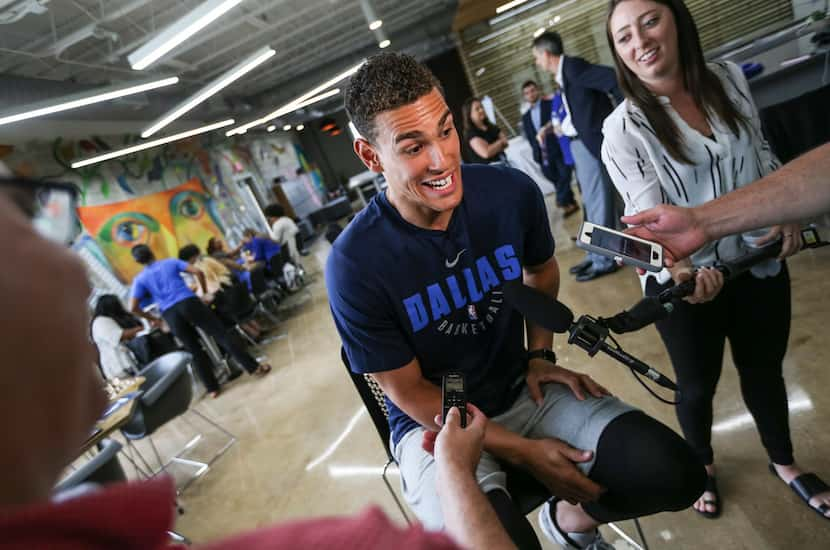 Dallas Mavericks player Dwight Powell talks members of the media as the Mavs Foundation, the...