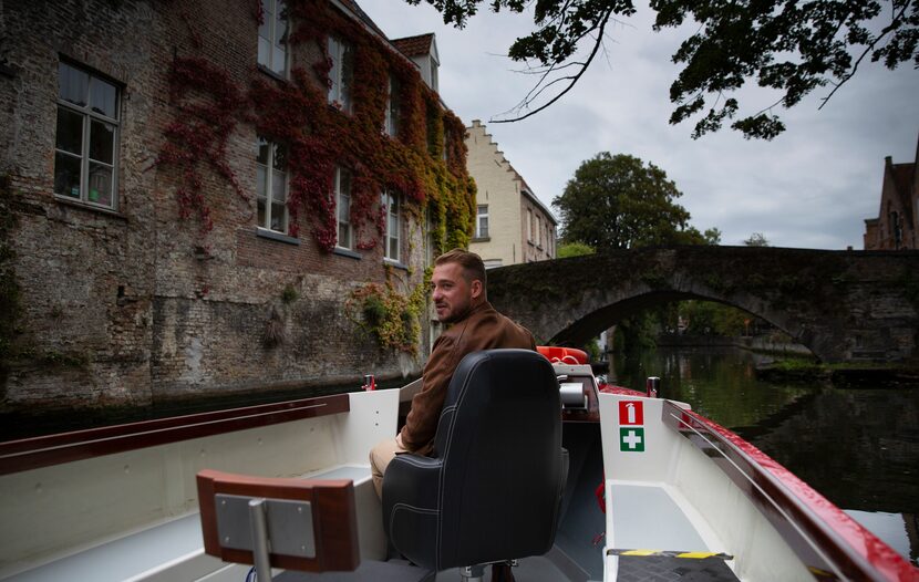 Fourth generation tour boat operator Michiel Michielsens drives his electric boat down a...