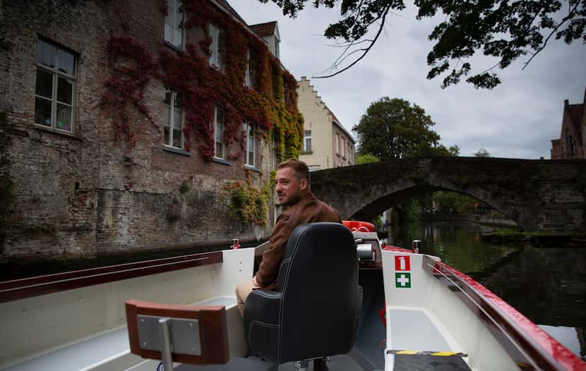 Fourth generation tour boat operator Michiel Michielsens drives his electric boat down a...