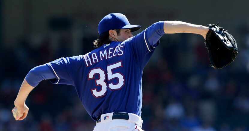 Texas Rangers starting pitcher Cole Hamels throws during the first inning of a baseball game...