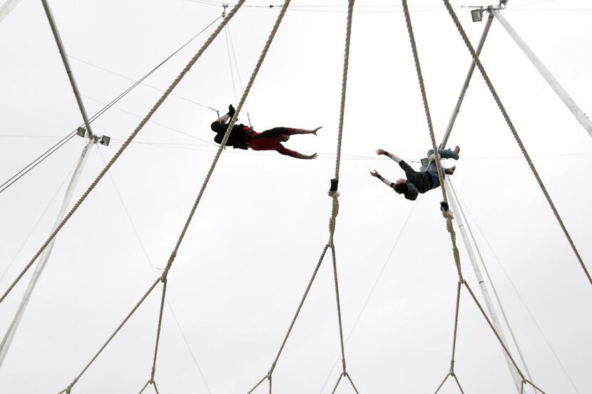 Jarrell Young, left, reached for trapeze artist Donovan Chandler during a trapeze class...