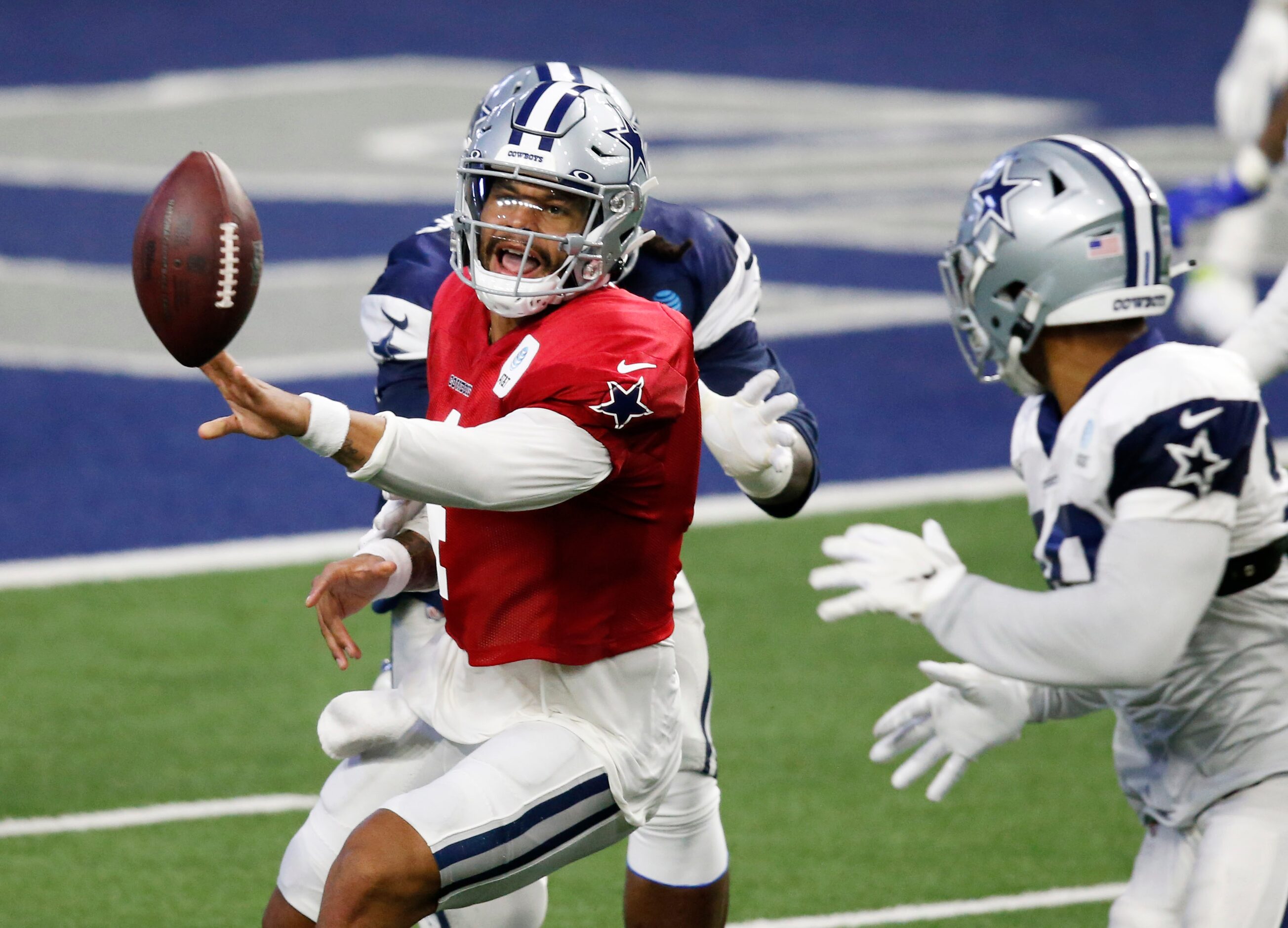 Dallas Cowboys quarterback Dak Prescott (4) hands the ball off to Dallas Cowboys running...