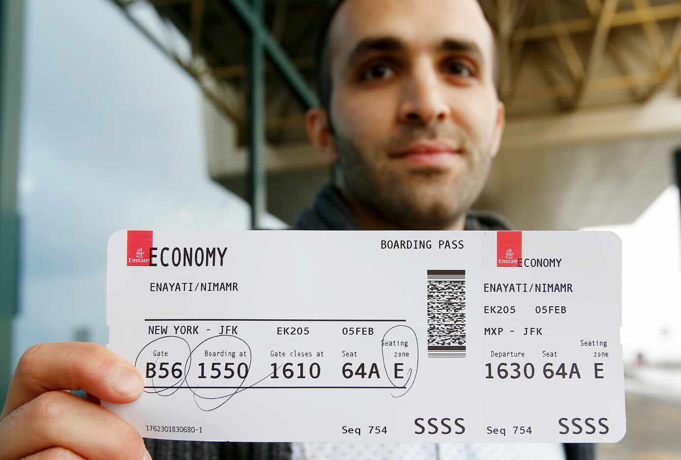 Iranian-born bioengineer researcher Nima Enayati shows his boarding pass at Milan's Malpensa...