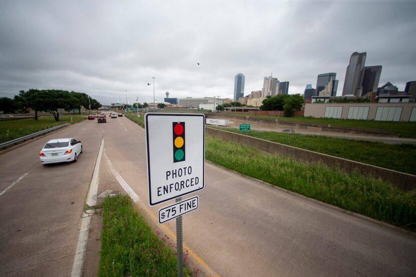 A red light camera warning sign is seen at the corner of South St. Paul Street and Griffin...