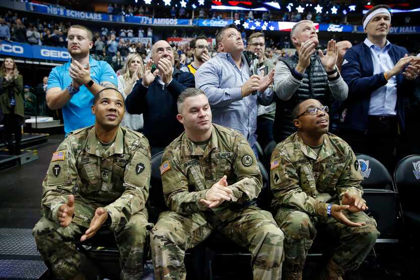 (from l to r) Staff sergeants Michael Reed, Zach Johnson and Scotty Scruggs look up as the...