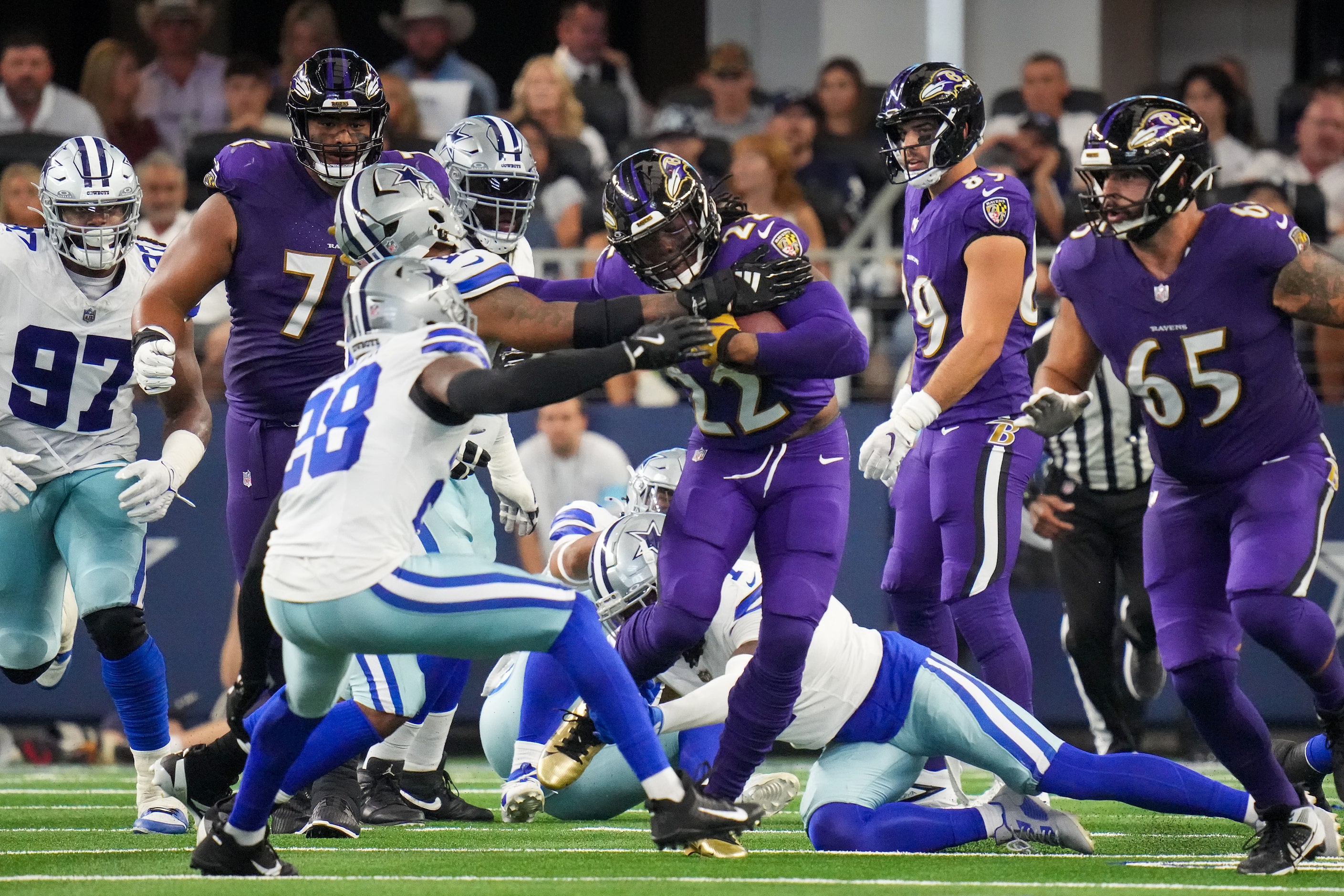 Baltimore Ravens running back Derrick Henry (22) breaks through the Dallas Cowboys defense...