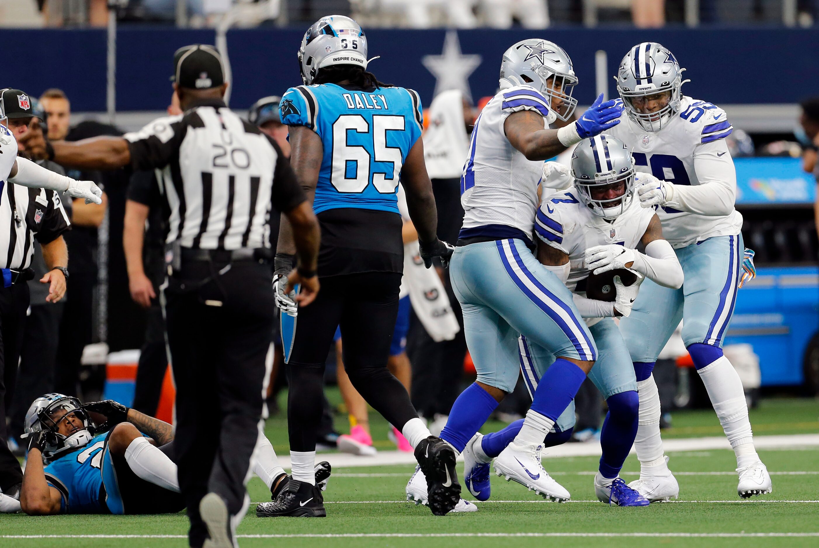 Dallas Cowboys cornerback Trevon Diggs (7) emerges from a pileup with the football for an...