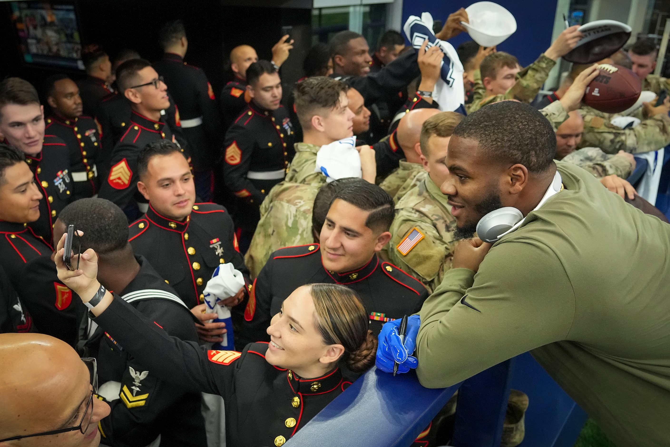 Dallas Cowboys outside linebacker Micah Parsons poses for a selfie while signing autographs...