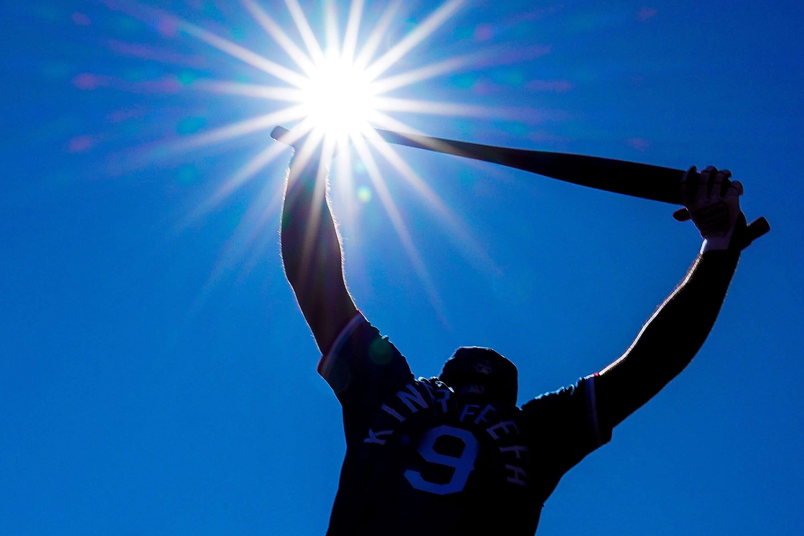 Texas Rangers infielder Isiah Kiner-Falefa loosens up before hitting during the first inning...