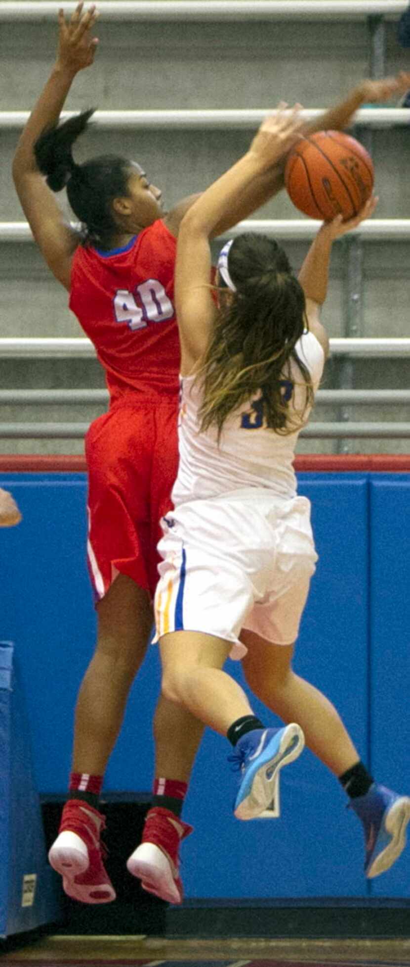 Garland Lakeview Centennial's Stephanie Villarreal (33) finds it challenging shooting over...
