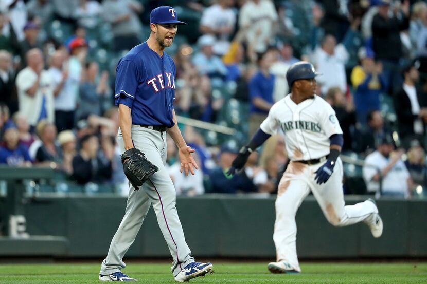 SEATTLE, WA - MAY 15: Mike Minor #36 of the Texas Rangers reacts after giving up a two-run...