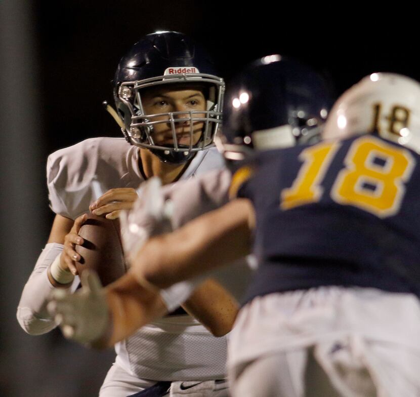 Argyle Christian quarterback Daniel Greek (12) looks downfield for a receiver that is open...