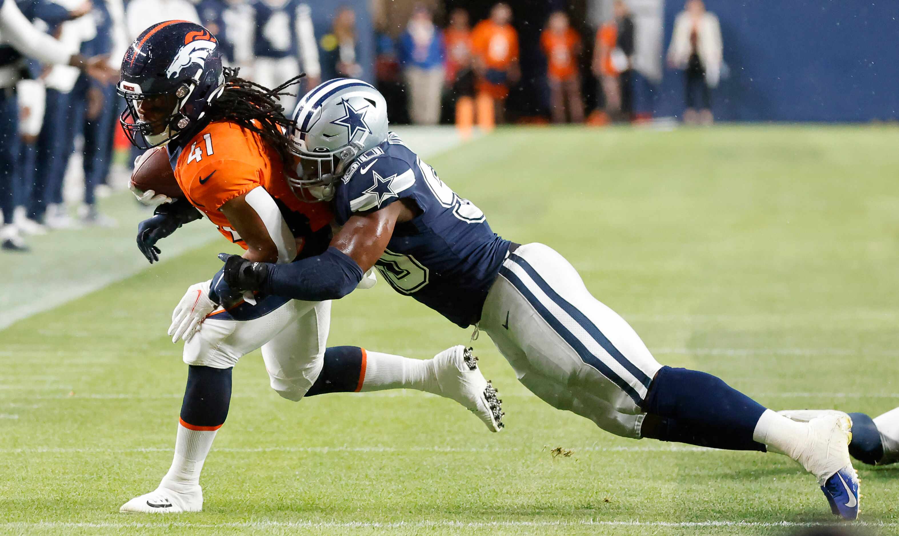 Dallas Cowboys linebacker Devin Harper (50) keeps Denver Broncos safety Jamar Johnson (41)...