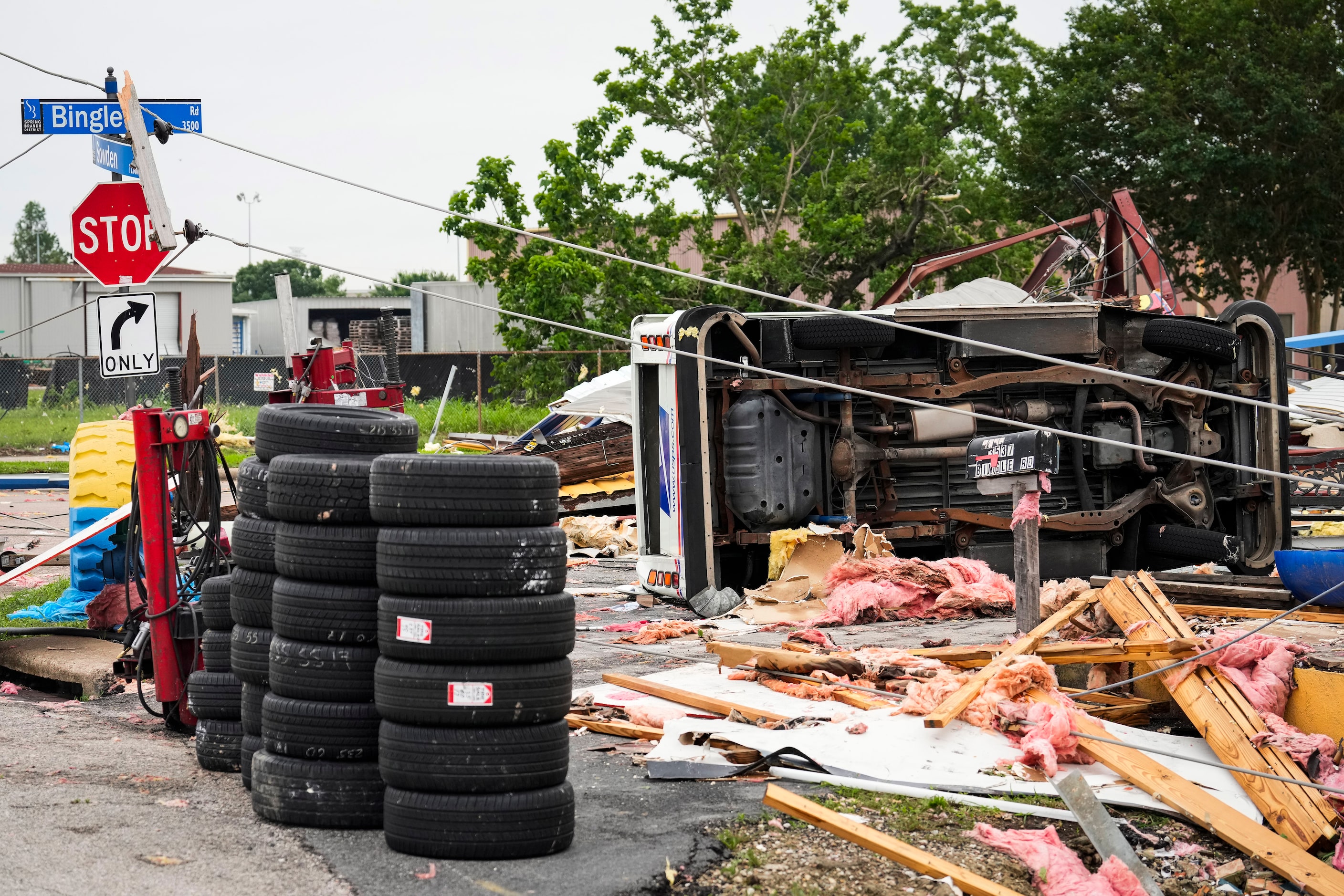 A U.S. Postal Service truck is flipped on its side at the intersection of Bingle and Sowden...