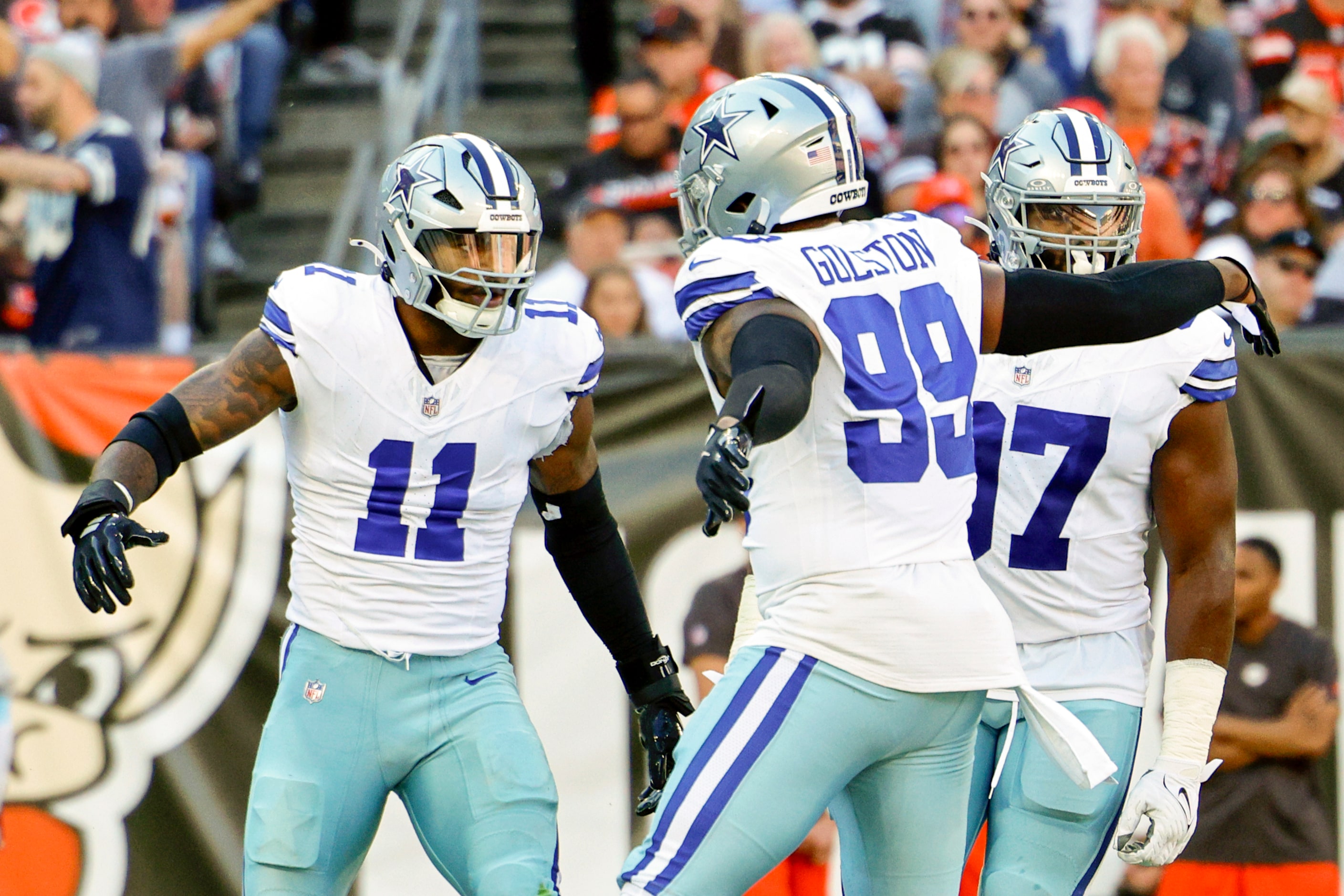 Dallas Cowboys linebacker Micah Parsons (11) high fives defensive end Chauncey Golston (99)...