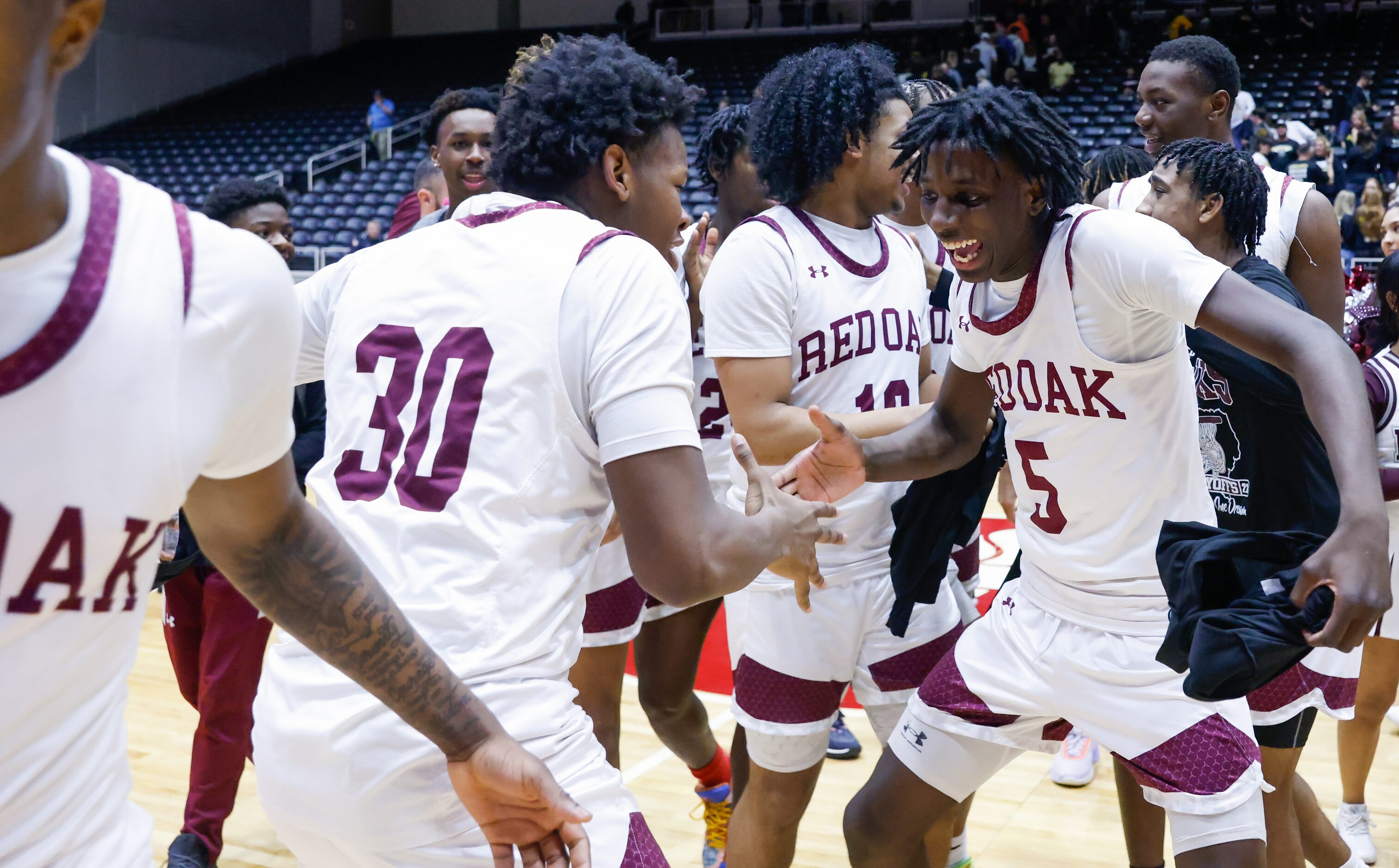 Red Oak senior forward Franklin Hunter (30) and junior guard Devin Boone (5) celebrate with...