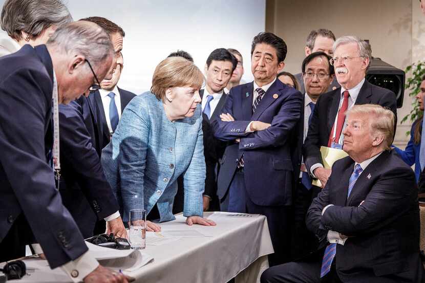 German Chancellor Angela Merkel speaks with President Donald Trump during the Group of 7...