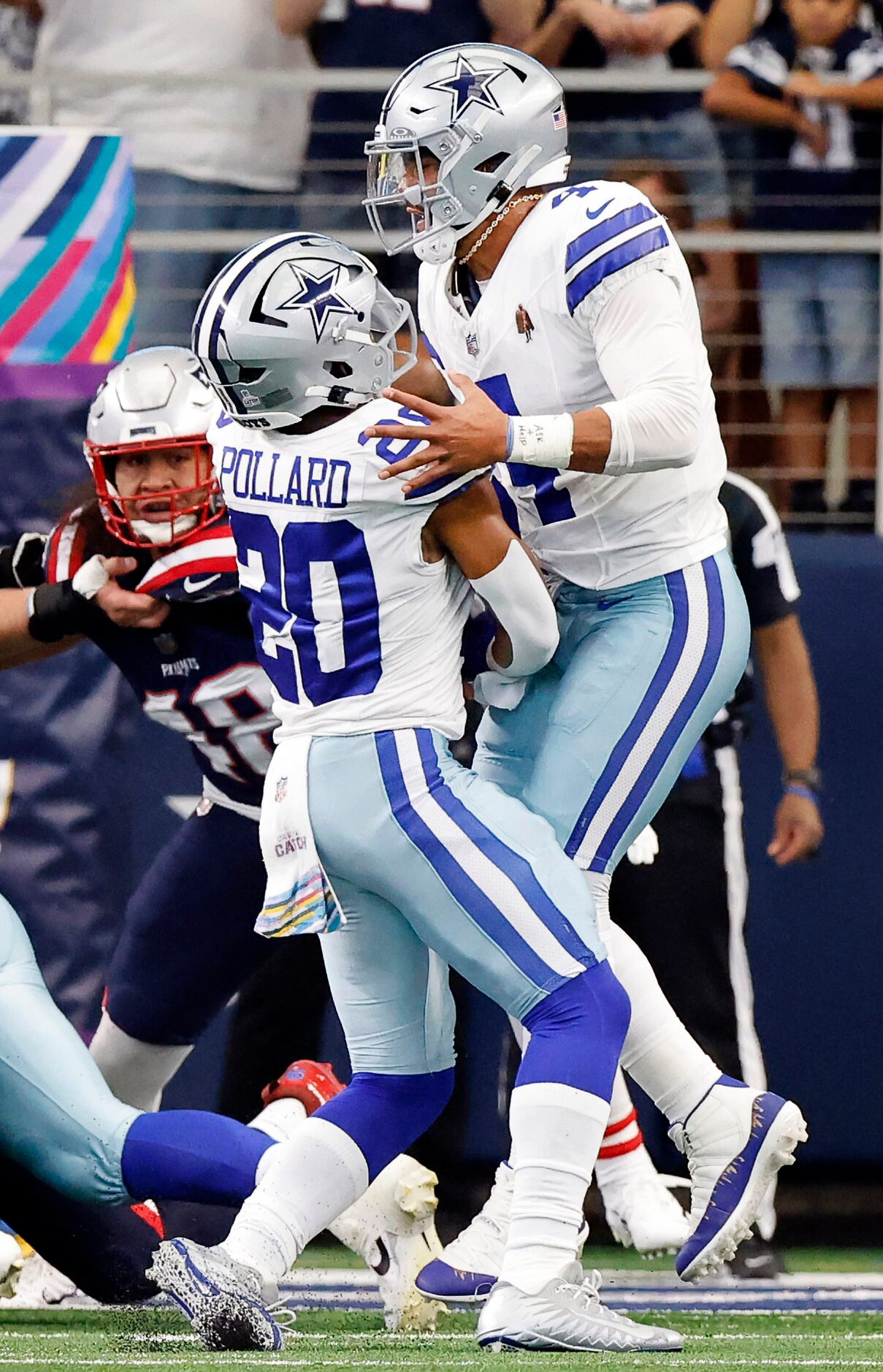 Dallas Cowboys running back Tony Pollard (20) runs into quarterback Dak Prescott (4) as he...