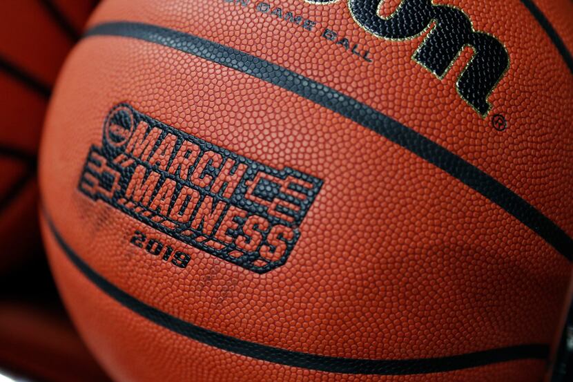A basketball with a logo is seen before a first round men's college basketball game between...
