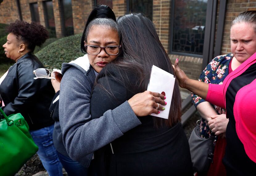 Tammy Kirk, mother of LaTiffiney Rodgers, receives hugs from friends and family after a...
