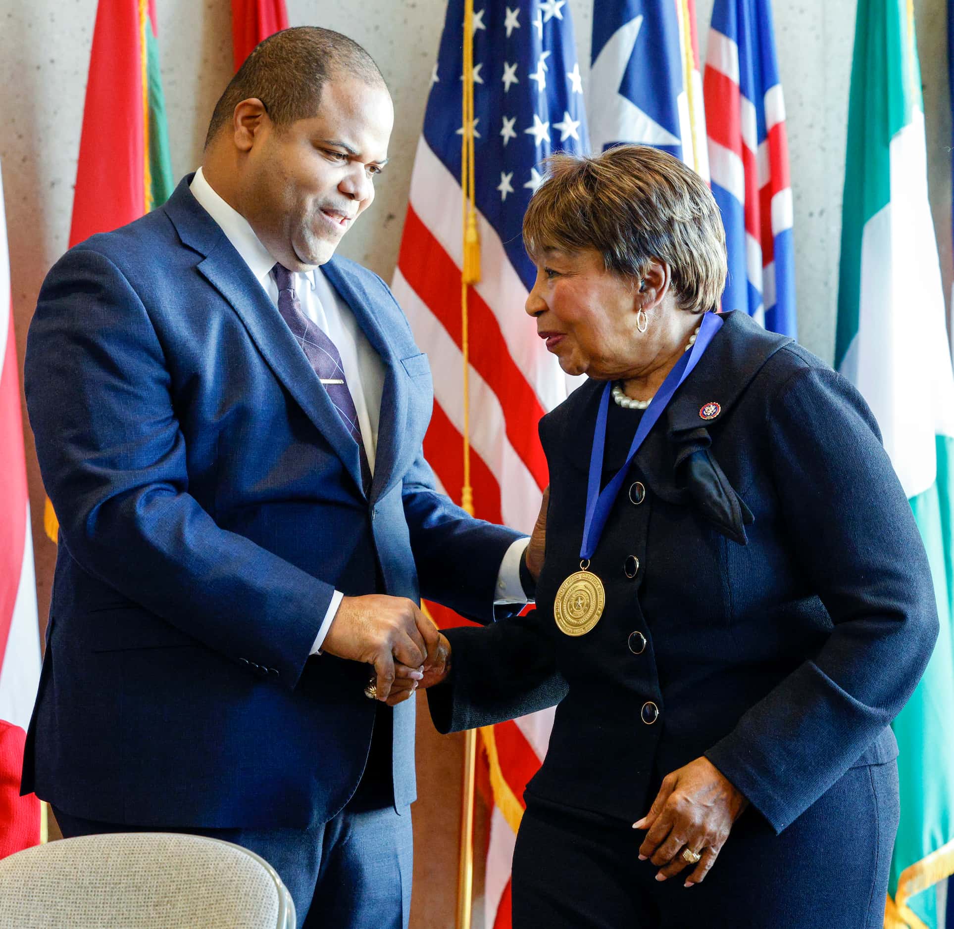 Dallas Mayor Eric Johnson congratulates U.S Rep. Eddie Bernice Johnson after presenting her...