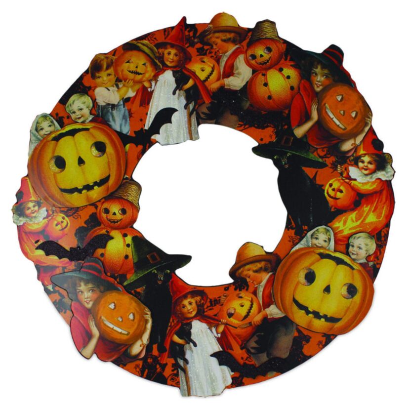 Ring of magic A three-dimensional, die-cut wreath of decoupage on wood with layered cutouts...