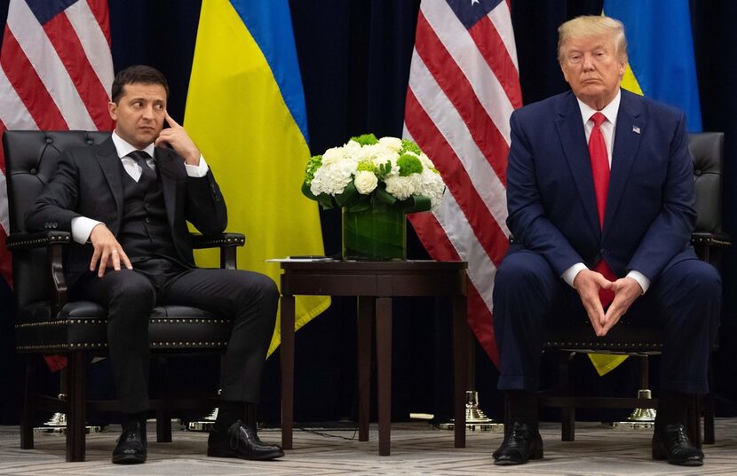 President Donald Trump and Ukrainian President Volodymyr Zelenskiy look on during a meeting...