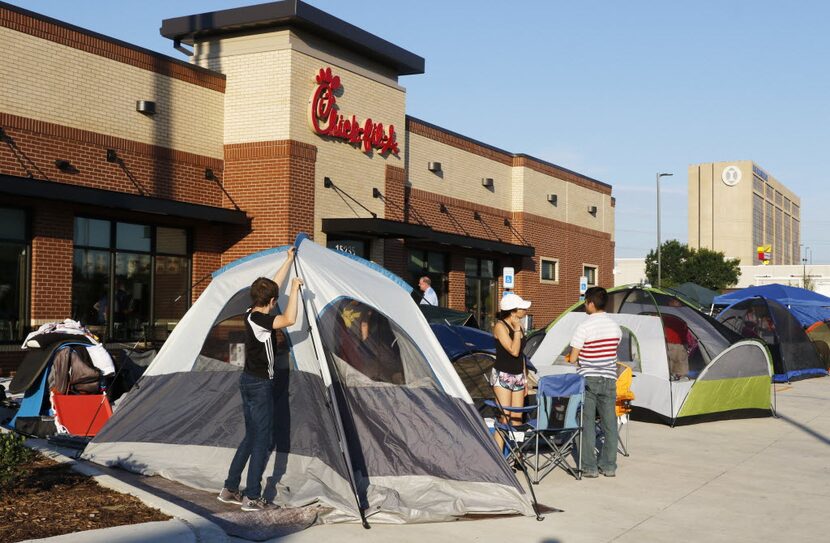 Grayson Ireland, 14, of Allen, helps pitch his tent. He's in line with his mother in hopes...