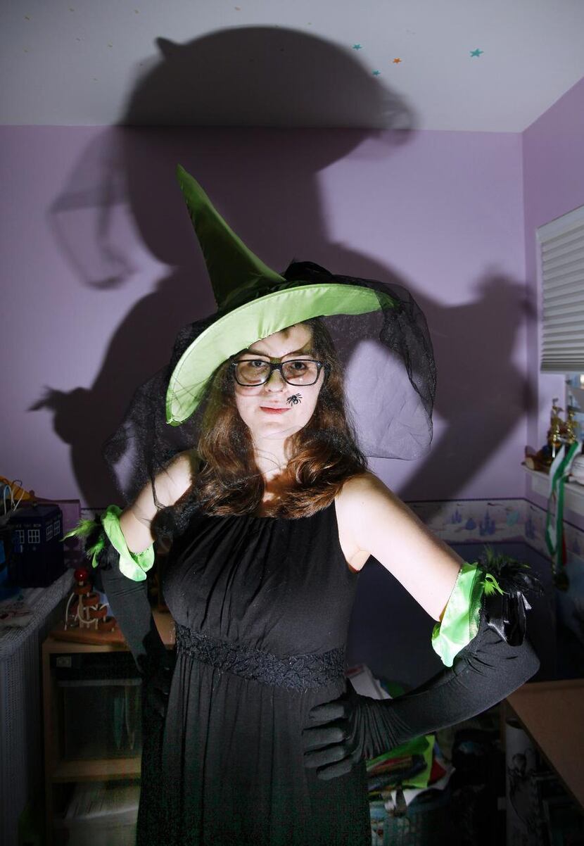 
Elena Atiles, 16, wears a witch hat and gloves that were part of the Elphaba costume she...