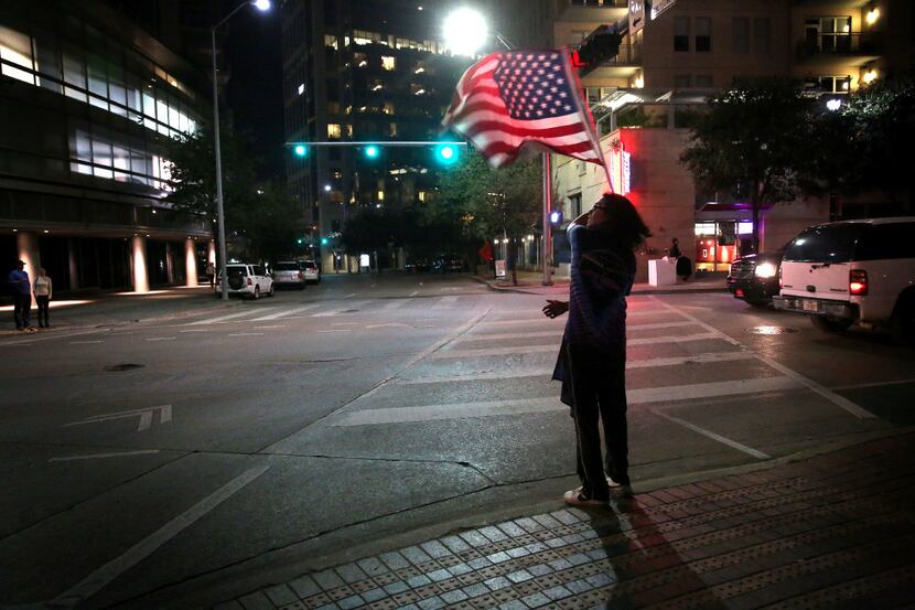 Hendrix Alamino waves an American flag during the Next Generation Action Network's protest...