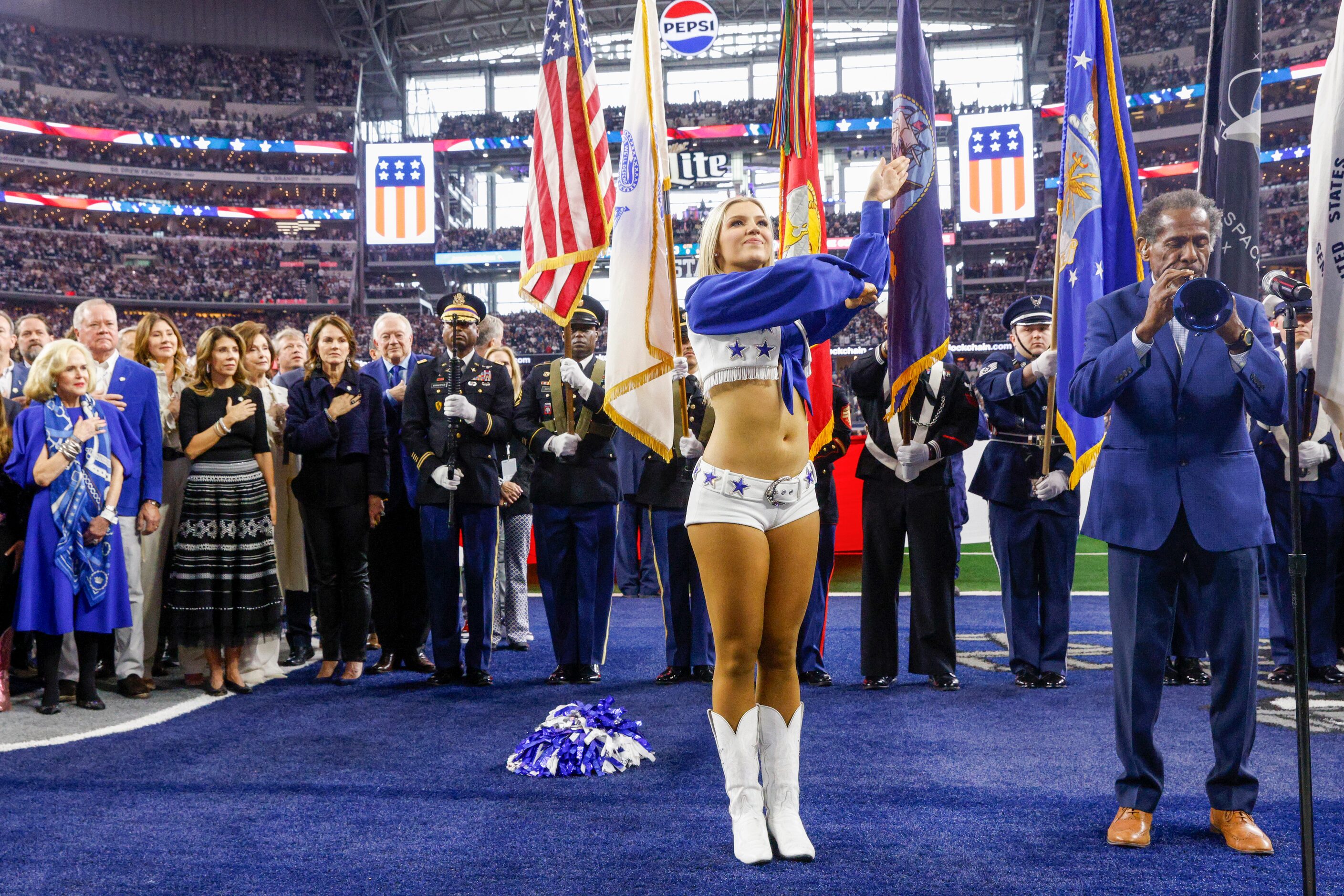 Trumpeter Freddie Jones performs the national anthem as a group representing the the...