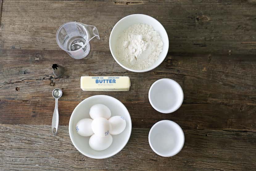 The ingredients for pate a choux, a special dough made by cooking butter, water, milk and...